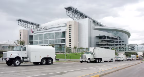 A convoy of emergency vehicles from Austin turn into Reliant Park in Houston