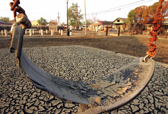 Dried mud from the floodwaters of Hurricane Katrina encrusts a children's swing in a playground in New Orleans on Sept. 18.
