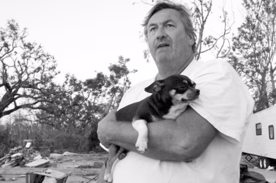 Brian Mollere with his mom's dog, Rocky, who he saved from Katrina's surge.