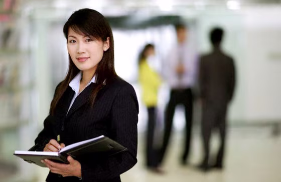 Businesswoman Writing in Notepad