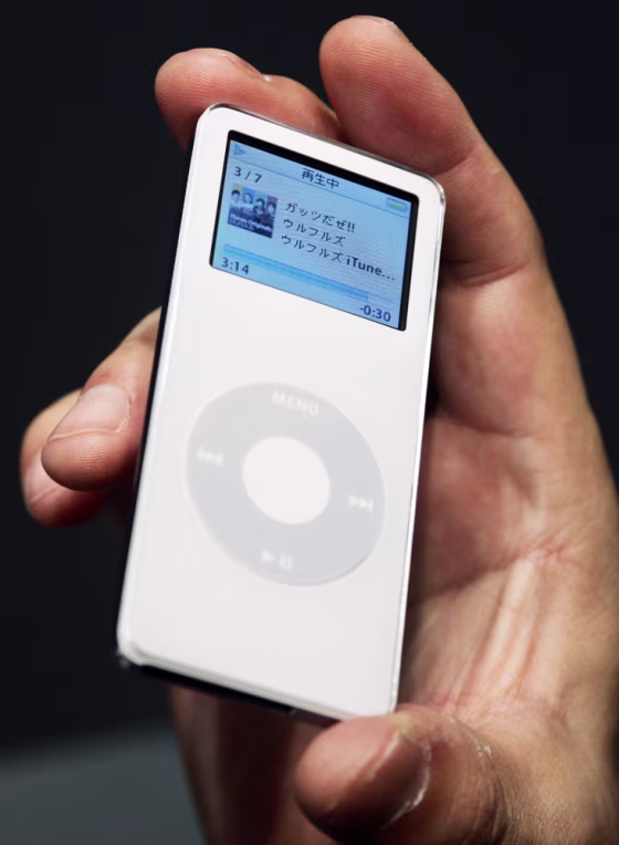 An Apple Computer Inc employee holds the new digital music player iPod Nano at a news conference in Tokyo