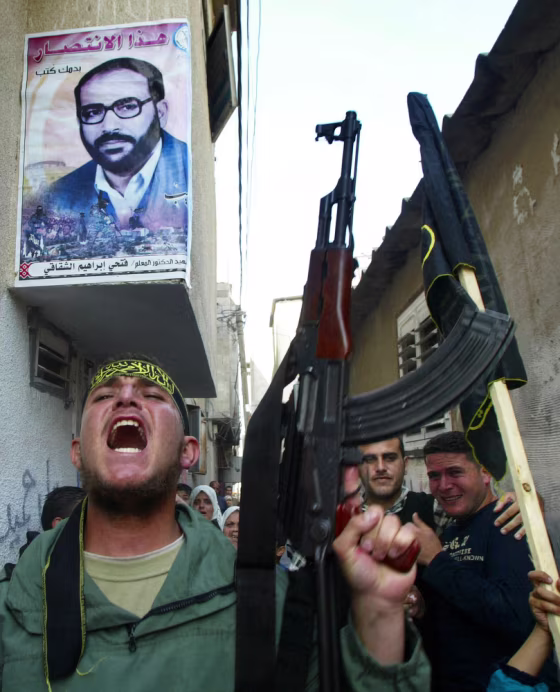 Relatives of Shadi Mohanna, an Islamic Jihad commander in the Gaza Strip, march through the streets of the&nbsp;Jebaliya refugee camp, adjacent to Gaza City, on Friday. Mohanna was among those killed in an Israeli airstrike Thursday night.