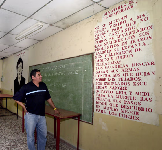 Julio Cesar Mendez, 42, reads a poem written on a wall at the "El Despertar" Catholic home of retirees in San Salvador, where a priest and four youths were assassinated by the army at the beginning of El Salvador's civil war in January 1979.