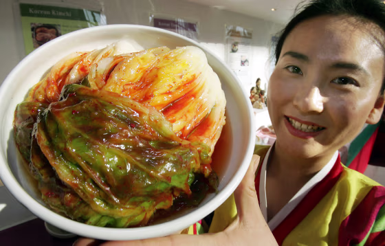A woman in traditional Korean dress hold