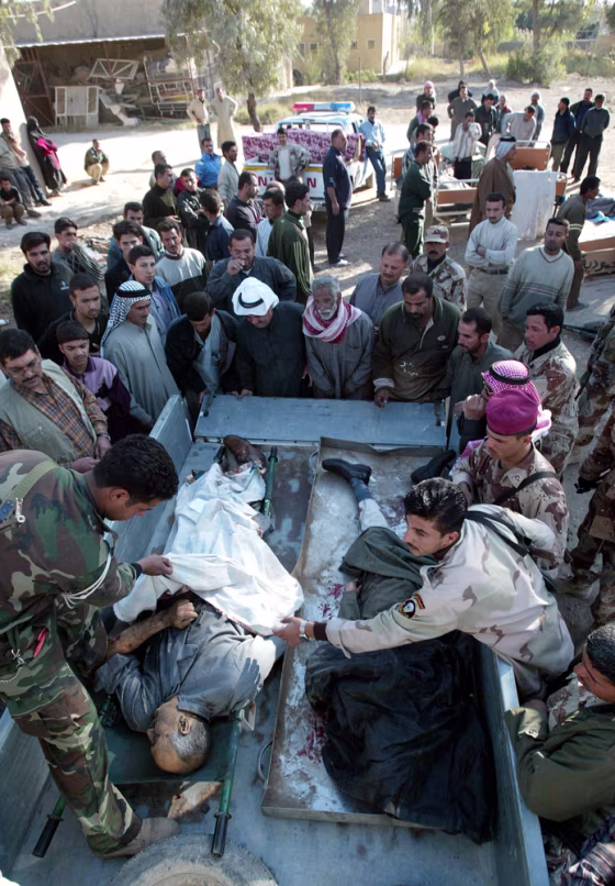 The bodies of people killed in a suicide car&nbsp;bombing Thursday are transported to the hospital in Mahmoudiya, Iraq.