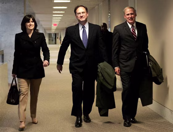 Supreme Court nominee Samuel Alito, center, walks&nbsp;Wednesday through the&nbsp;Hart Senate Building on Capitol Hill, with&nbsp;two associates&nbsp;for meetings with senators. 