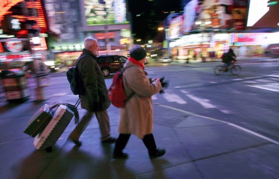 Paul Leendertz, and his wife Felice, of Wageningen, Holland, walk through New York's Times Square, on Wednesday,&nbsp;as the transit&nbsp;strike enters its second day.