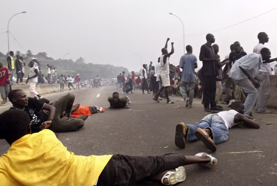 Supporters of Ivorian President Gbagbo run for cover in Abidjan