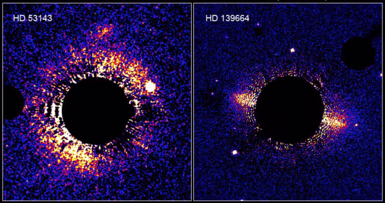 These two bright&nbsp;debris&nbsp;disks of dust and ice, spotted by the Hubble Space Telescope,&nbsp;appear to be the equivalent of our own solar system's Kuiper Disk. In each case, the glare of the central star has been blotted out by a black disk.