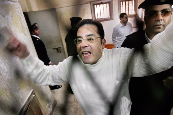 Leading government opponent Ayman Nour shouts to supporters through the bars of the defendant's dock in a Cairo courtroom before being forcibly removed by police, after he was sentenced to five years' imprisonment for forgery in December. The year-long judicial process drew international criticism and uproar.