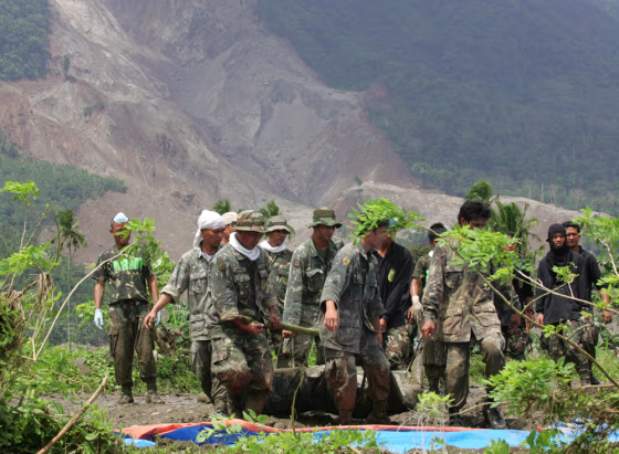 SOLDIERS CARRY LANDSLIDE VICTIM