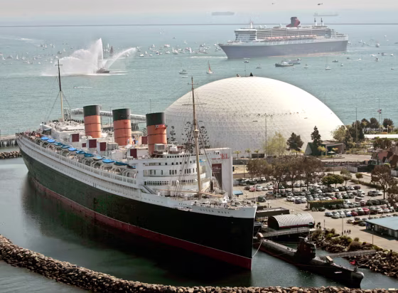 The Queen Mary 2, the world's largest ocean liner, top right, moves near its historic namesake the Queen Mary, docked below,&nbsp;Feb. 23,&nbsp;at the Long Beach Harbor, in Long Beach, Calif. 