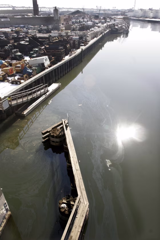 An oil sheen swirls atop Newton Creek in the Greenpoint section of Brooklyn, New York, last&nbsp;Feb. 16. Some local&nbsp;residents have sued Exxon, Chevron and BP to force the expedited cleanup of an estimated 17-million-barrel underground oil spill containing more petroleum than the Exxon Valdez dumped off Alaska.