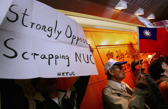 Protesters hold placard and flag of Taiwan during rally outside Chung Hwa Travel Service in Hong Kong