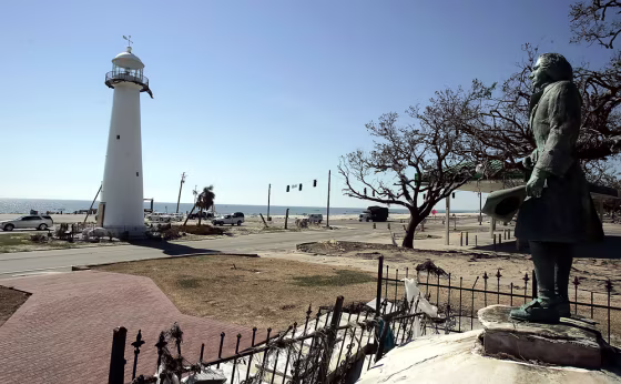 A statue of explorer Pierre LeMoyne d'Iberville looks out at the lighthouse along U.S. Highway 90 in Biloxi, Miss. The big question: When will the tourists come back? 