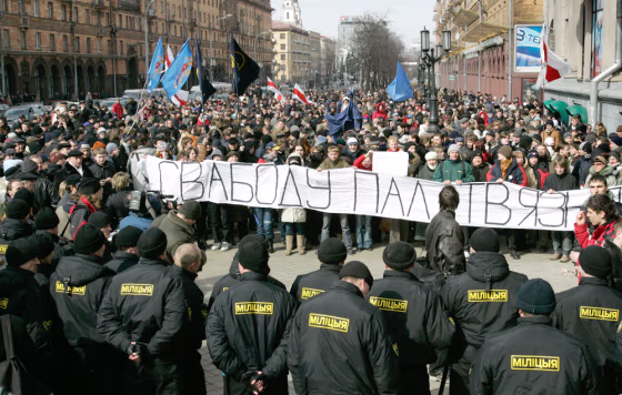 Riot police confront oppositon supporters during a demonstration in Minsk, Belarus, on Saturday. The banner reads "Freedom for political prisoners."