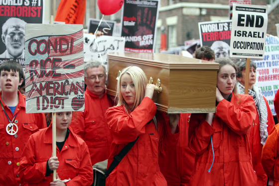 Protesters carry a coffin towards the Ph