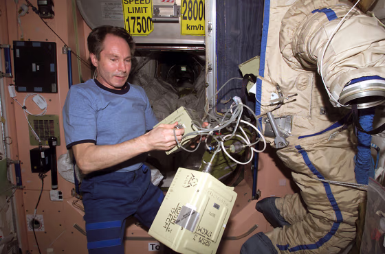 Russian cosmonaut Valery Tokarev puts the finishing touches on an old Russian spacesuit that was released from the international space station as a "SuitSat" amateur-radio satellite during a February spacewalk.