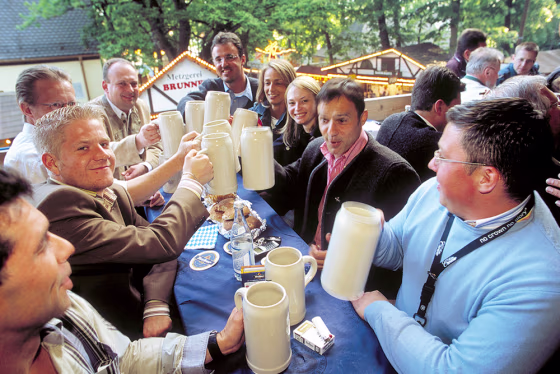 Visitors clink mugs at the annual festival called Bergkirchweih in Erlangen, southern Germany, in May 2005.