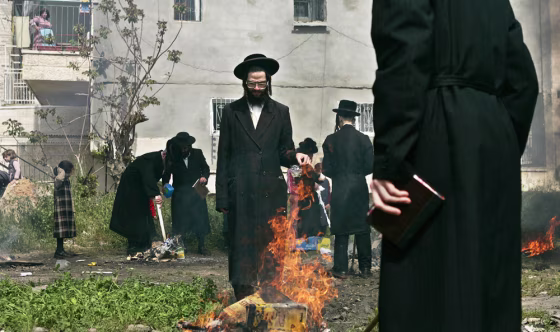 Orthodox Jews gather around a fire Wednesday as they burn leavened items in final preparation for Passover in Jerusalem. All leavened food such as bread is forbidden to Jews during the week-long holiday.