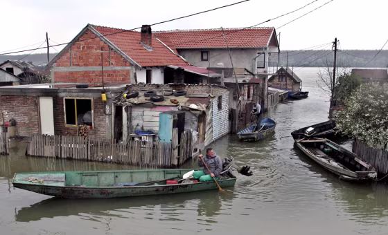 People in a boat inspect a home flooded by the Danube river, in Smederevo, south of Belgrade, on Thursday. Serbia has declared a state of emergency in the northern parts of the country after weeks of flooding throughout central Europe.