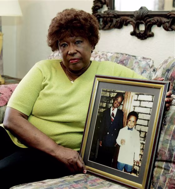 Jannie Coverdale poses on April 14 at her home in Oklahoma City with a photo of her grandsons, Aaron, left in the photo, and Elijah, who were killed in the Oklahoma City bombing in 1995.