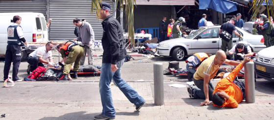 Israeli medical personnel help wounded civilians, following a suicide attack at Tel Aviv's old central bus station