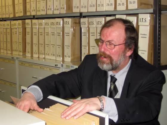 Udo Jost, a staff member at the International Tracing Service, combs through a file cabinet of Nazi-era records in Bad Arolsen, Germany.