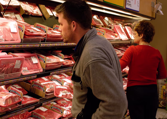 Dan Hogan, left, looks for a good cut of meat&nbsp; at the Cub Foods grocery store in Burnsville, Minn.