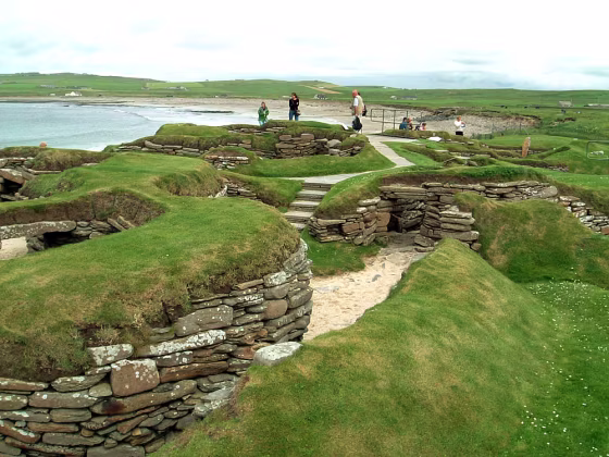 Visitors look at the 5,000 year-old remains of Skara Brae village in the Scottish Orkney Islands, July 19, 2005, which was revealed by a huge storm in 1850. 