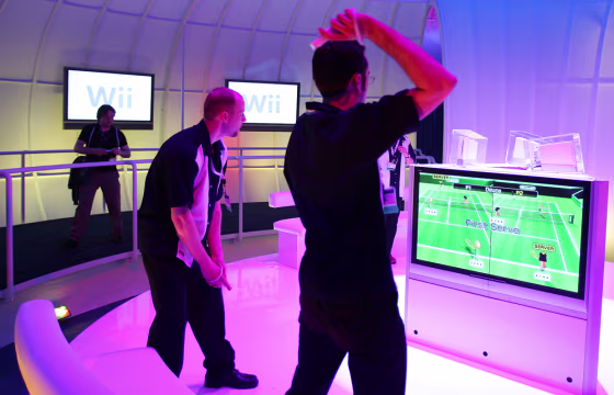 Nintendo game demonstrators play tennis