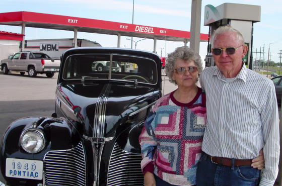 Carl and Frances Barrier stand beside their 1940 Pontiac at a service station in Salina, Kan. on May 12, en route to a car club meeting in Minden, Neb. Their car gets about 10 miles per gallon, they said, but high gasoline prices have not lessened their enthusiasm for the antigue vehicle.