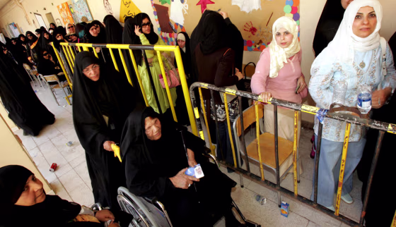 Kuwaiti women wait for their turn to vote at polling station in Kuwait City