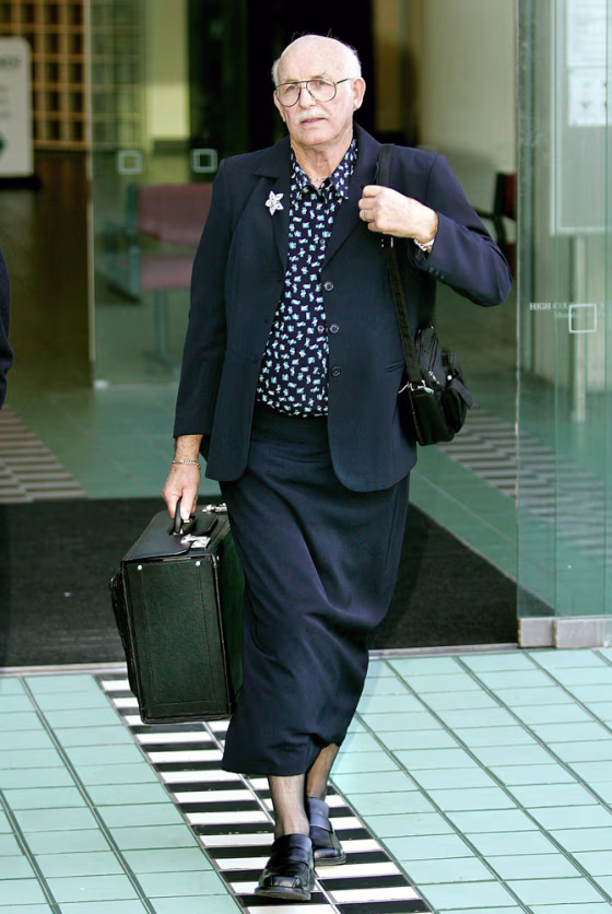 New Zealand lawyer Moodie walks out of high court in Wellington wearing women's stockings and skirt