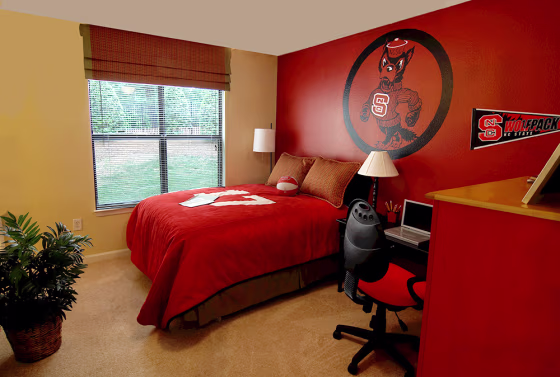 A bedroom in the University Village at Raleigh condominium complex near North Carolina State University is seen in this photo from real estate developer The Priess Company. Residents of the 3 bedroom, 3 bathroom units also have access to a clubhouse with a game room and an outdoor pool.