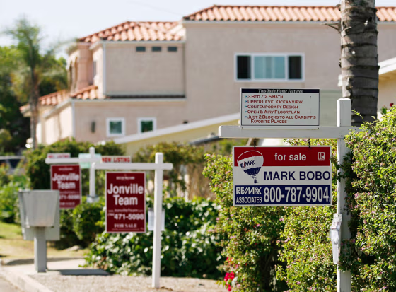 Real estate signs advertise the sale of three homes in a row in Encinitas, Calif. last week. As California's housing market slows, year-over-year prices in San Diego County fell in June for the first time since the state's housing boom began there six years ago.&nbsp; 