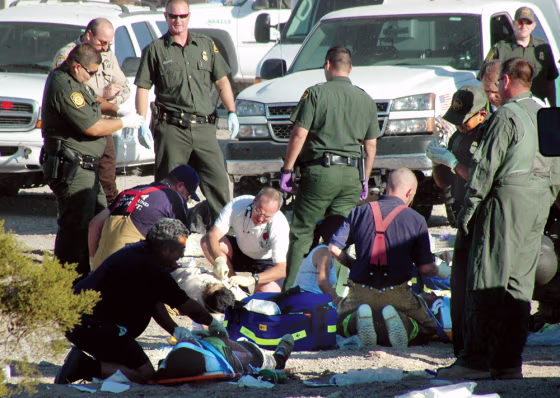 Rescuers and paramedics work at&nbsp;the scene of&nbsp;the accident involving a sport utility vehicle&nbsp;crowded with suspected illegal immigrants near Yuma, Ariz., Monday. 
