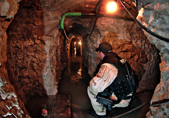 A U.S. Immigration and Customs Enforcement agent looks down&nbsp;a shaft of a tunnel leading from the U.S. into Mexico in this Jan. 30 file photo. Federal agents have arrested Mexican drug lord Francisco Javier Arellano-Felix, a leader of a major violent gang&nbsp;accused of&nbsp;digging the tunnels.