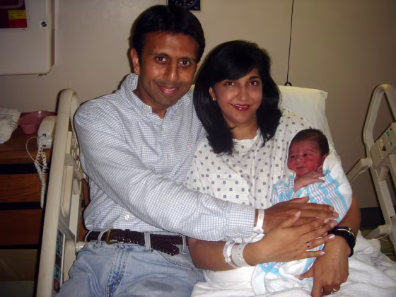 Rep. Bobby Jindal, left, his wife, Supriya, and their newborn son, Slade Ryan, sit in a hospital on Wednesday after Jindal helped deliver the couple’s third child.