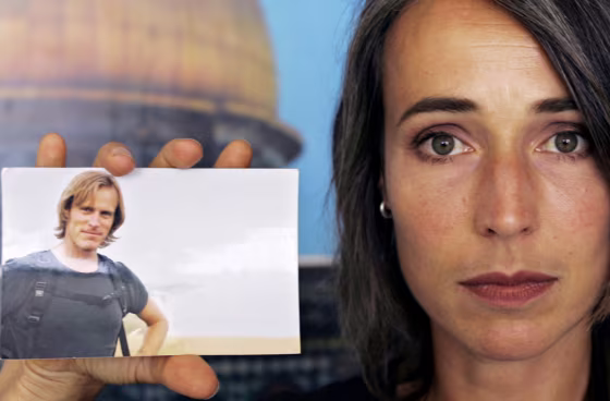 Anita McNaught holds a picture of her husband Olaf Wiig, 36, a Fox News cameraman from New Zealand who was kidnapped in Gaza City.