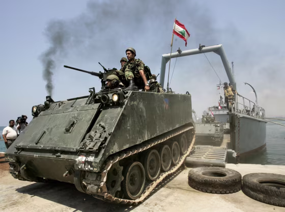 Lebanese soldiers who will be deployed to the south of the country drive an armored vehicle&nbsp;out of a navy ship at the port in Tyre on Thursday.