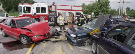 Firefighters work at the scene of a three-car accident in Berlin, Vt., on&nbsp;July 25. More than half of passengers killed in traffic deaths in 2005 were not wearing seatbelts, according to an annual report.