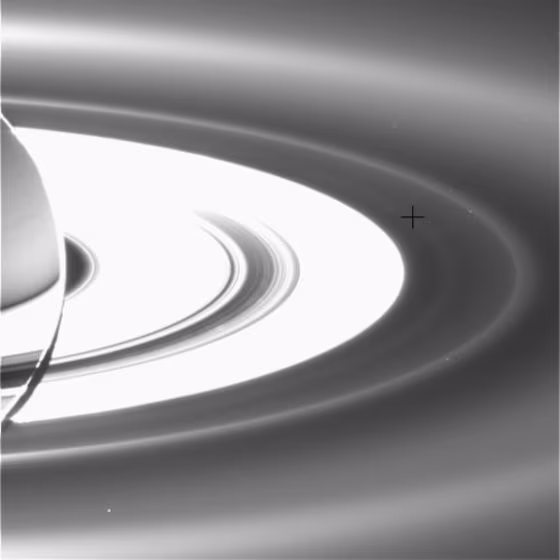 A newly detected ring of Saturn lies&nbsp;outside the main rings and inside the outer G and E rings. A black cross has been added to this picture to&nbsp;mark the location of the faint, diffuse ring.