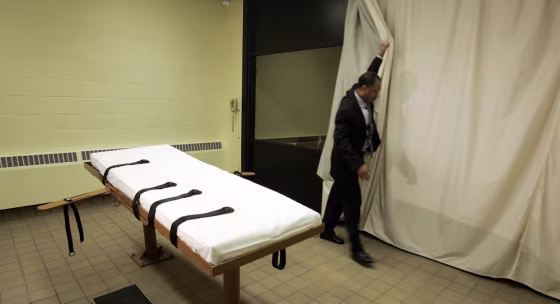 In this November 2005 photo, public information director Larry Greene&nbsp;shows how a curtain is pulled between the death chamber and witness room at Southern Ohio Corrections Facility in Lucasville, Ohio. The facility maintains detailed logs of Death Row inmates' last days.
