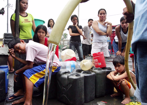 Residents line up&nbsp;to get&nbsp;water on&nbsp;Saturday in Manila, Philippines, two days after Typhoon Xangsane hit the city, cutting off water and electricity supplies.
