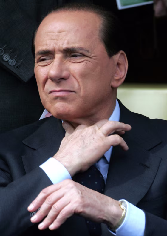 File photo of Italy's former PM Berlusconi adjusting his tie while watching a military parade in Rome
