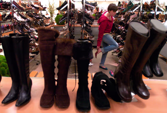 Alexandra Klaus of Glastonbury, Conn., shops for shoes at Macy's in Manchester, Conn., early Tuesday. Retailers were ushering in the post-Christmas shopping season by slashing prices even more on holiday items and stocking up on fresh new merchandise.