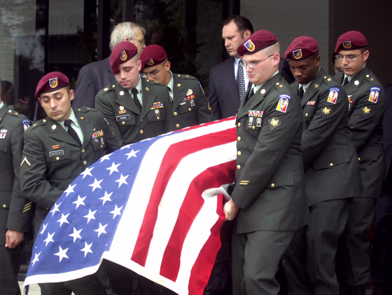 Members of the U.S. Army Garrison HHC from Fort Polk, La., carry the casket of Army Staff Sgt. Jacob Gerald McMillan after a funeral service Friday at Lafayette Memorial Park Cemetery in Lafayette, La. McMillan died in Iraq on Dec. 20 from wounds he suffered when a roadside bomb exploded near his vehicle.