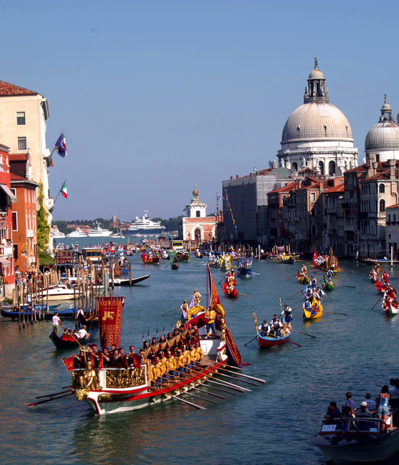 The Bucintoro, the barge of Venice's ruler, the Doge, leads a parade of historical venetian boats as it sails along the Grand Canal during the Historical Regatta, in Venice, Italy.