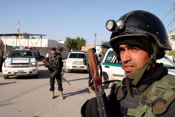 Iraqi soldiers guard central Karbala, Iraq, on Monday after gunmen stormed provincial headquarters in an attack that left five U.S. soldiers dead.